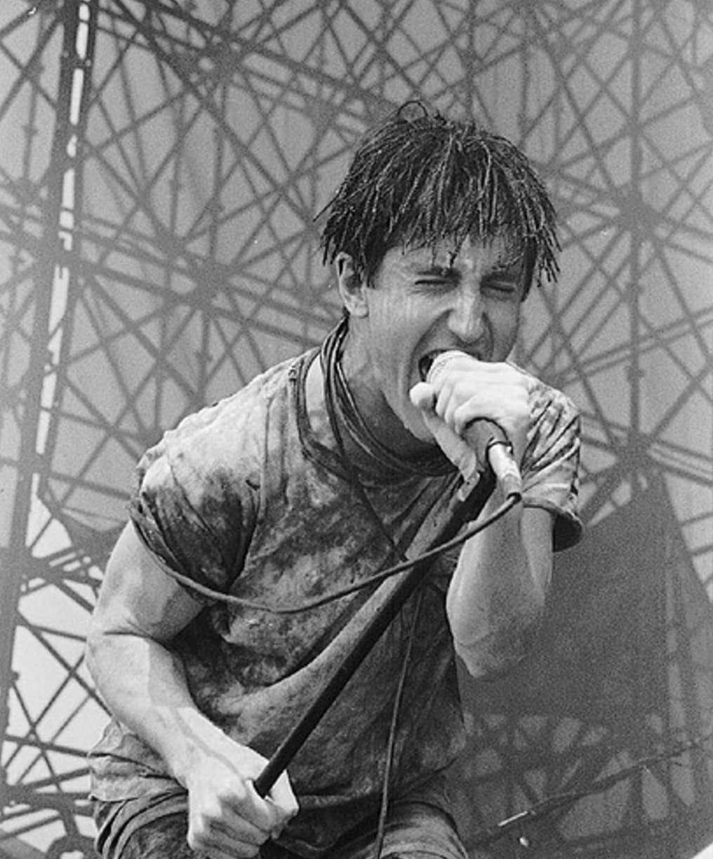 The only thing harder than Nine Inch Nails’ music? Their fashion. During their peak in the late ‘80s and early ‘90s, the band’s love of leather, acid-washed pants, and metallic details heralded an entire style movement. 